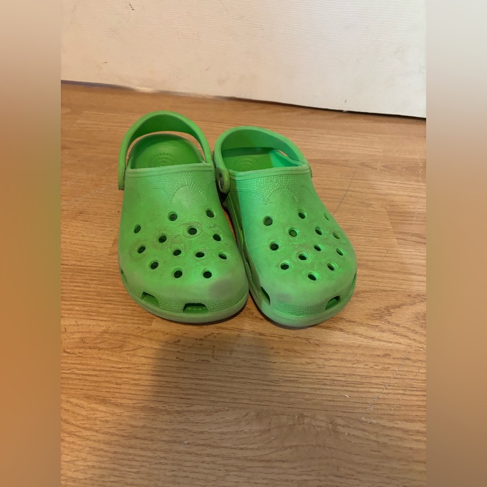 Woman’s green crocs
